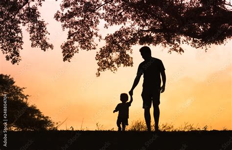 Father And Son Holding Hands Walking In The Park Stock Photo Adobe Stock