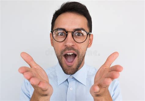 Studio Portrait Of Handsome Happy Man Achieves Goals Wearing Blue