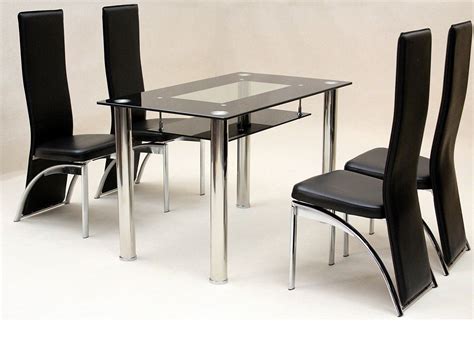 Round glass top of this element looks very interesting and provides support for food and drinks. Small glass dining table and 4 faux chairs in black - Homegenies