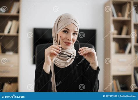 Confident Positive Muslim Woman In Formal Wear And Hijab Holding