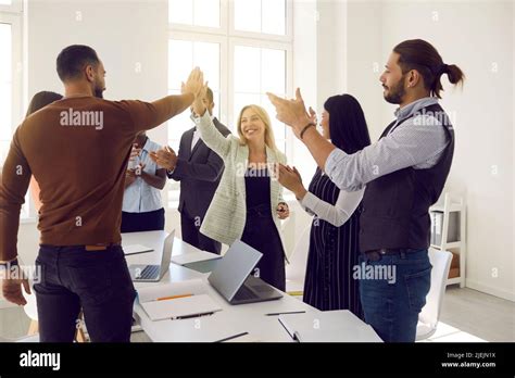 Team Of Happy Young Business People Celebrating Success Clapping Hands