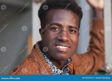 Handsome Confident Smiling Young Black Man In Leather Jacket Stock