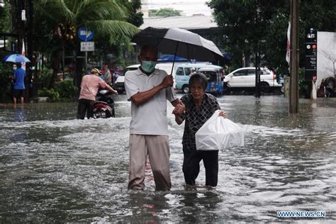 People Walk Through Flood Water After Heavy Rain In Jakarta Indonesia