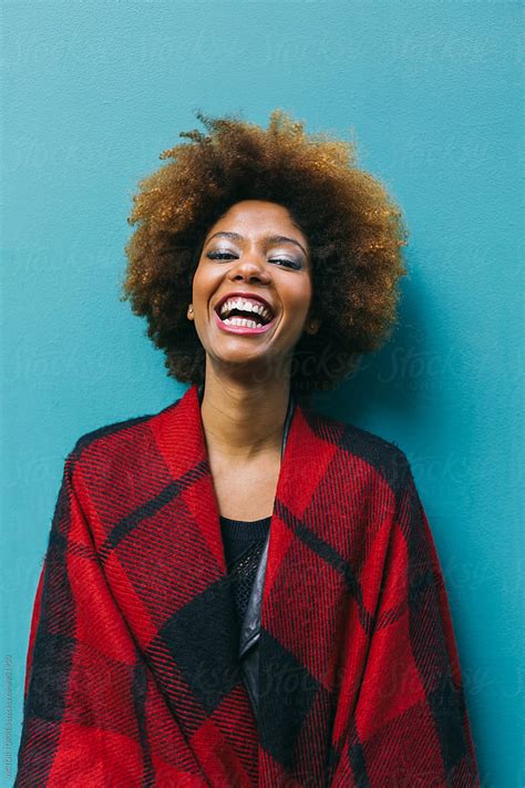 Beautiful Afro Woman Over A Blue Background By Stocksy Contributor