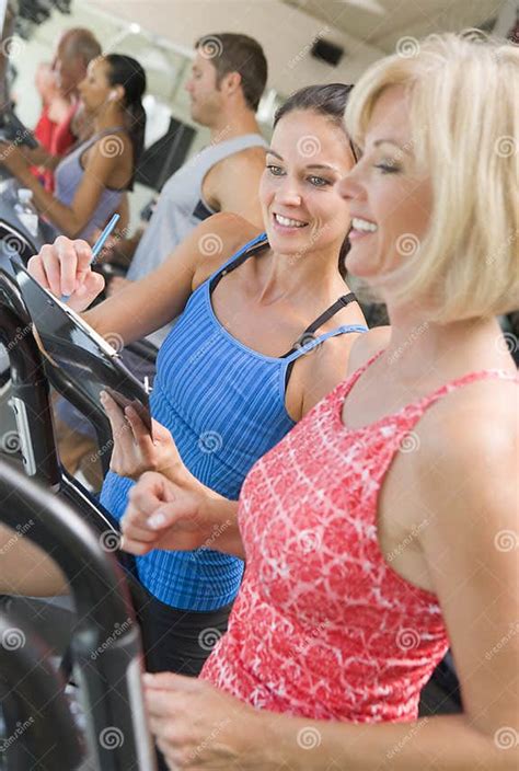 Personal Trainer Instructing Woman On Treadmill Stock Photo Image Of