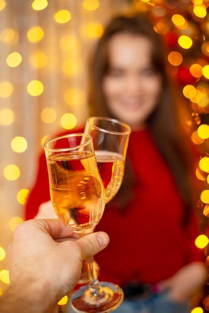 Premium Photo Two Persons Clink Glasses Full Of Champagne New Years Eve Celebrating Together