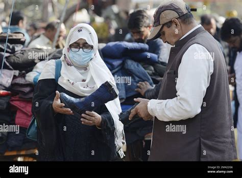 Islamabad, Pakistan. 18th Dec, 2022. People buy shoes at a flea market