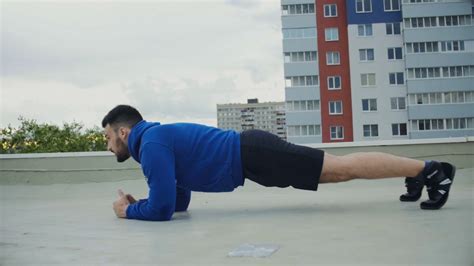 Cinematic Plank Workout For Male Athlete On The Roof Stock Video