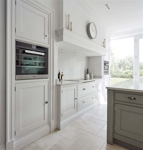 For subtle contrast, two different shades of the same calm colour tend to work better on cabinetry than three or four, which can look like a design mistake. Grey Shaker Kitchen | Tom Howley