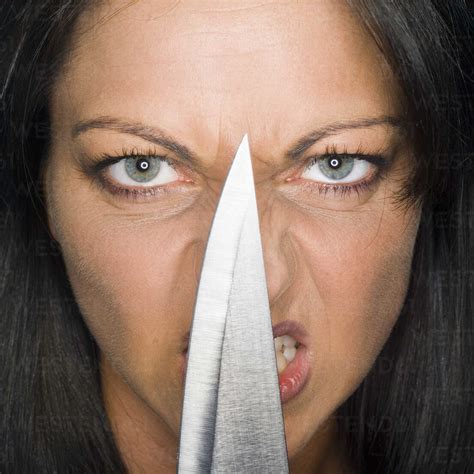 Young Woman Holding Knife Portrait Close Up Stock Photo
