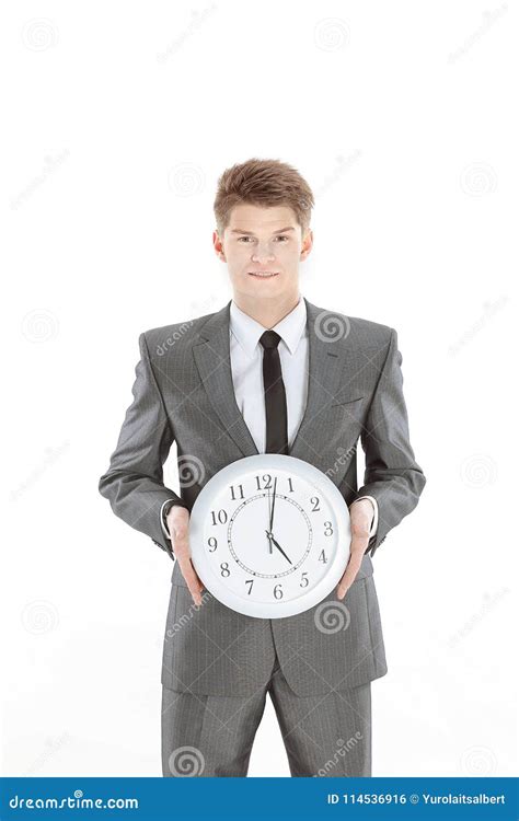 Handsome Businessman Holding A Large Clockisolated On A White Stock