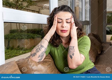 Brazilian Tattooed And Worried With Both Hands On Her Head Temple