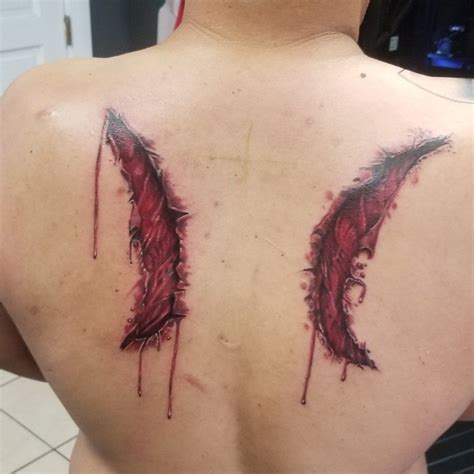 broken angel wings tattoo