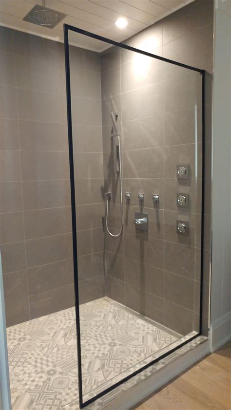 fixed glass shower enclosure with a matte black frame elegant and show stopping glass