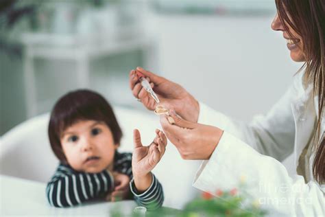 Homeopath Giving Remedy To Child Photograph By Microgen Imagesscience