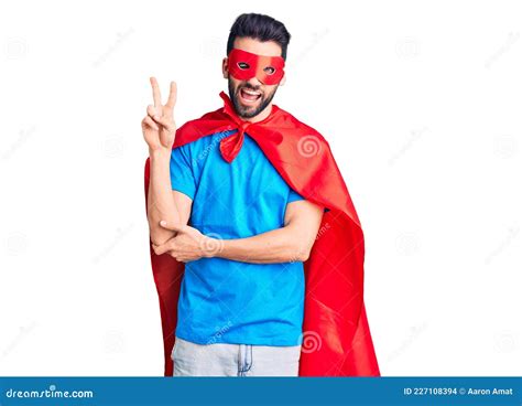 Young Handsome Man With Beard Wearing Super Hero Costume Smiling With