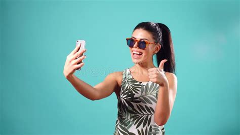 Beauty Playful Brunette Woman In Dress And Glasses Posing And Making Selfie On Her Smartphone