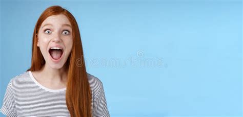 amused thrilled enthusiastic surprised good looking redhead girl wide eyes stunned drop jaw