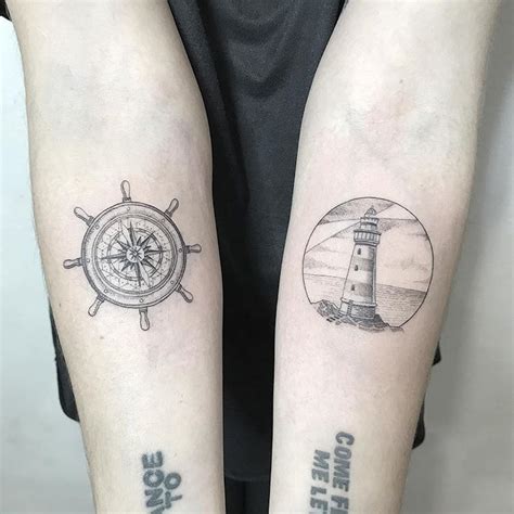 Ship Wheel And Lighthouse Tattoos On Both Inner Forearms Lighthouse
