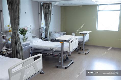 Modern Hospital Ward With Empty Beds Medical Monitor Green Curtains