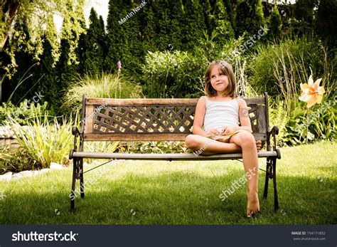 Daydreaming Child Portrait Little Girl Sitting On Bench Outdoor In