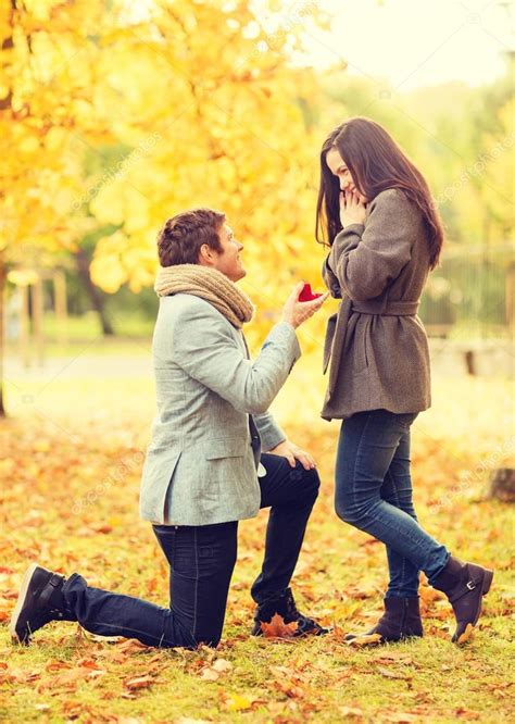 Man Proposing To A Woman In The Autumn Park Stock Photo By ©syda
