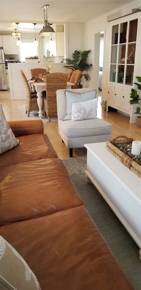a living room filled with furniture next to a kitchen