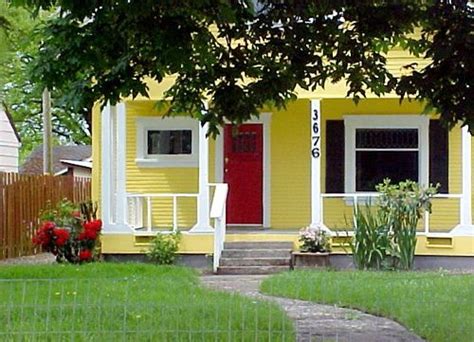 Oak trim has an orange undertone, so the wall color must look good with orange. Yellow House with Red Door in 2020 | Yellow houses, House ...