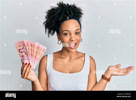 Young African American Girl Holding Thai Baht Banknotes Celebrating
