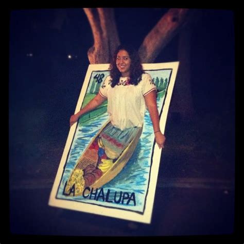 a woman holding up a poster with a canoe on it that says chalupa