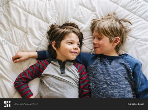 Brothers Lying Together On A Bed Cuddling Stock Photo Offset
