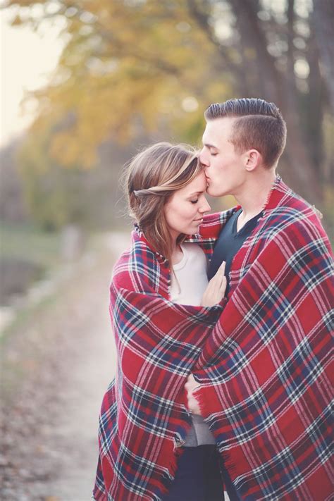 Plaid blanket in engagement pictures session at the park. Outdoor ...