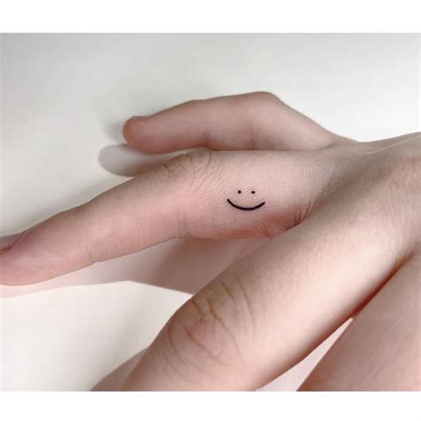 Smiley Tattoo Located On The Finger Minimalistic