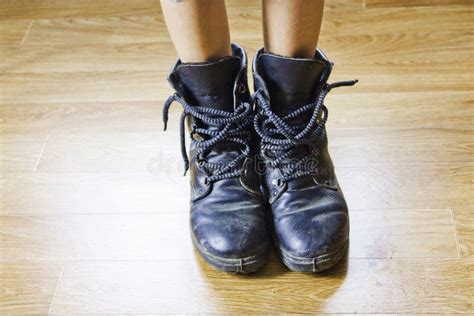 Big Shoes To Fill Child S Feet In Large Black Shoes Stock Photo