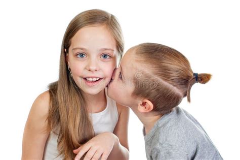 Young Smiling Caucasian Boy And Girl Kisses Him On The Cheek Stock