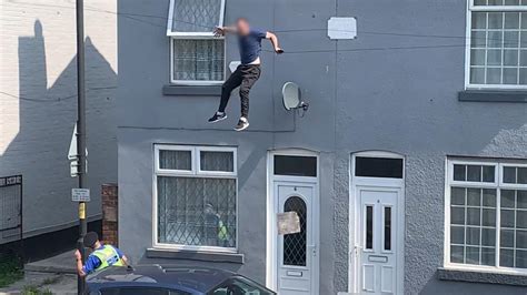 Shocking Moment Man Falls From Roof While Evading Police During