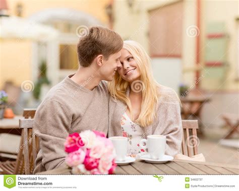 Romantic Happy Couple Kissing In The Cafe Stock Image