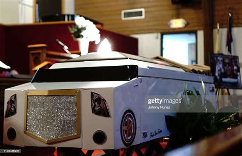 A View Of The Casket Which Resembles A Limousine During The Funeral