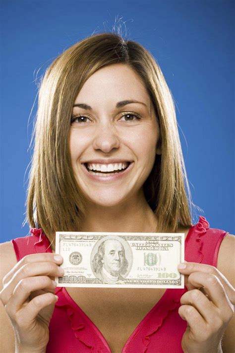 Closeup Of Nude Woman Holding One Hundred Dollar Bills Over Her Breasts