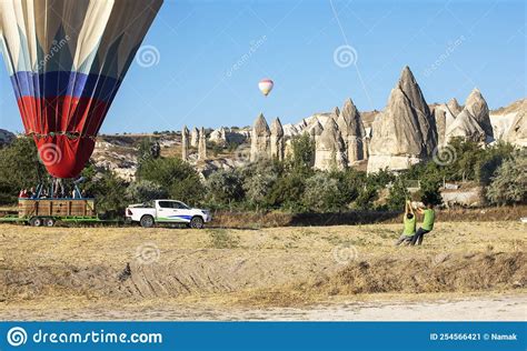 Employees Help To Land A Huge Blue Balloon With People In Cappadocia