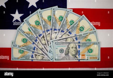 One Hundred Dollar Bills Fanned Out On The America Flag Stock Photo Alamy