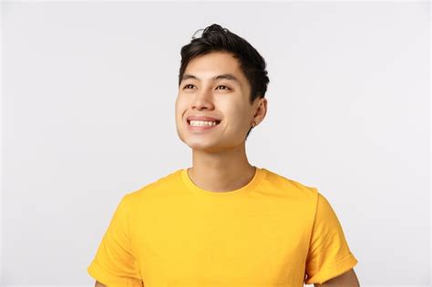Premium Photo Handsome Young Asian Man In Yellow T Shirt Smiling