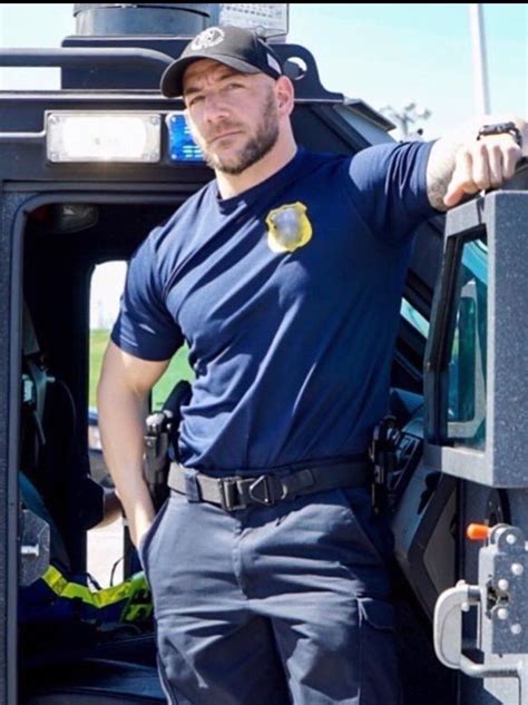 A Police Officer Standing In The Back Of A Truck