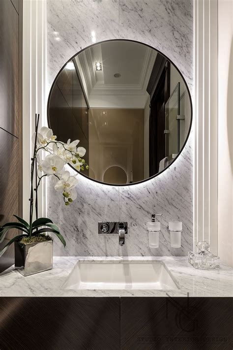 Elegant long and narrow ivory wainscot powder room is illuminated by a white glass bulb pendant hung from an ivory wainscot ceiling above a wood herringbone floor in front of a inset vanity mirrors fixed above a porcelain and brass sink vanity finished with an antique brass faucet. 10+ Beautiful Breathtaking Powder Room Ideas | Modern ...