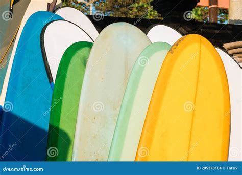 Close Up Stack Of Colorful Surfboards On Beach Background For Rent