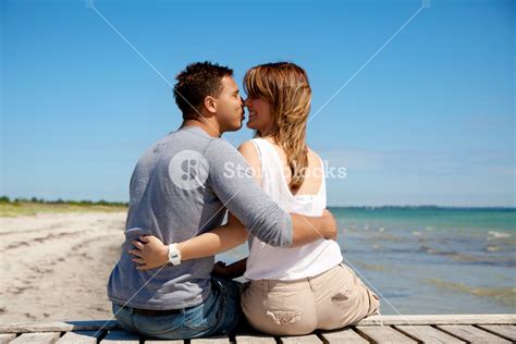 Couple Kissing On A Beach And Enjoying Their Honeymoon Royalty Free