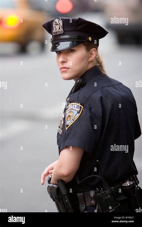 A Female Police Officer Watches Traffic In New York City New York Usa