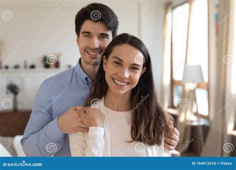 Portrait Of Happy Couple Hug Pose In New Home Stock Photo Image Of
