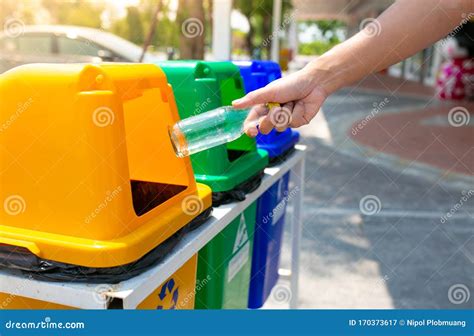 Man Hand Throwing Plastic In Recycling Bin To Help Environmental
