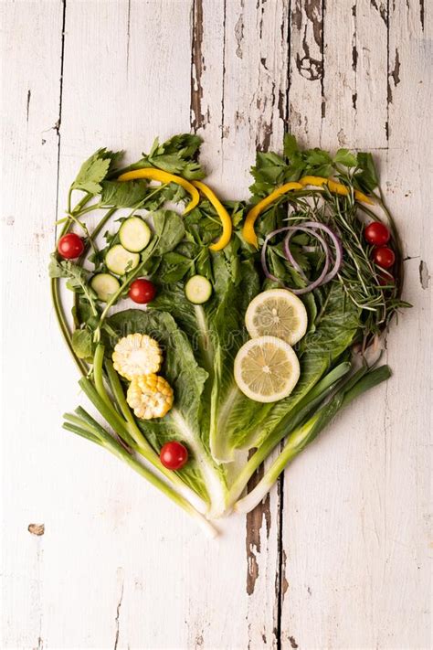 Overhead View Of Fresh Green Vegetables Arranged As Heart Shape On